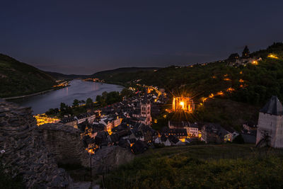 High angle view of illuminated buildings against sky at night