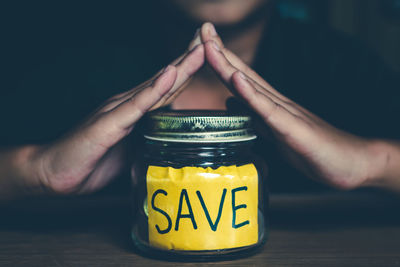 Close-up of hand holding drink in jar