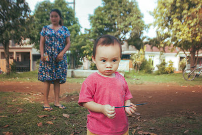 Portrait of boy standing on land