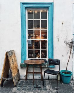 Chairs and table against window of old building