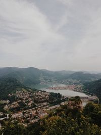 High angle view of river amidst city against sky