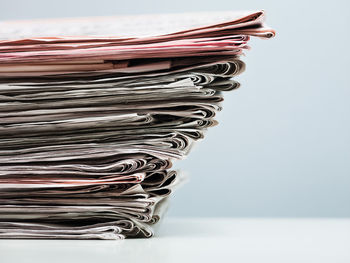 Close-up of papers on table against white background
