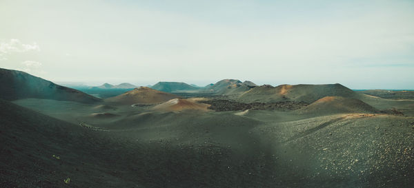 Scenic view of arid landscape against sky