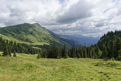 Scenic view of landscape and mountains against sky