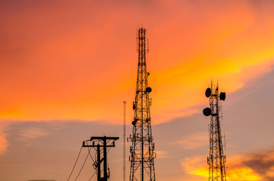 Silhouette of communications tower against sky during sunset