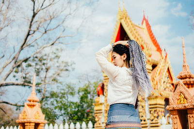 Midsection of woman standing at temple