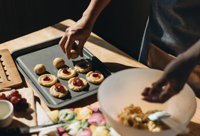 Close-up of person preparing food on table