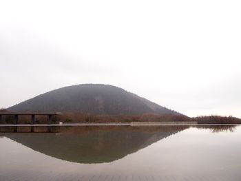 Scenic view of lake and mountains against clear sky