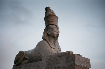 Low angle view of statue against sky