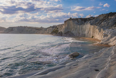 Scenic view of sea and mountains against sky