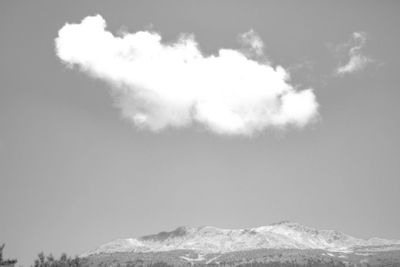 Low angle view of snowcapped mountain against sky