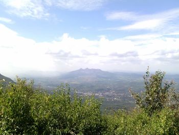 Scenic view of mountains against cloudy sky