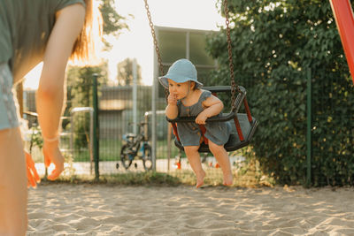 Full length of woman standing on slide at playground