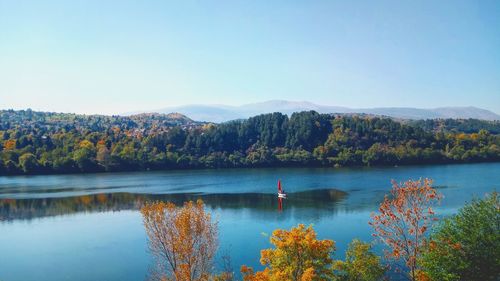 Scenic view of lake against clear blue sky