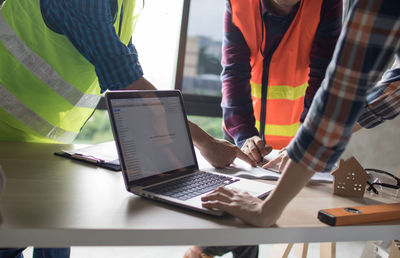 Low angle view of people working on table