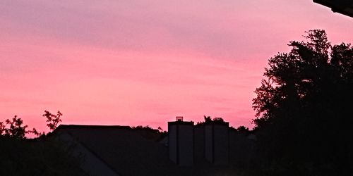 Low angle view of silhouette trees against sky during sunset