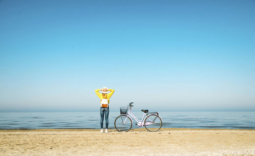 Bicycle on beach against clear sky