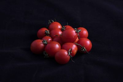 Close-up of cherries over black background