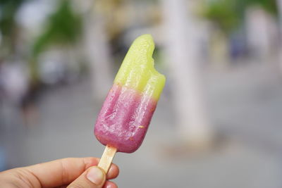 Close-up of hand holding ice cream