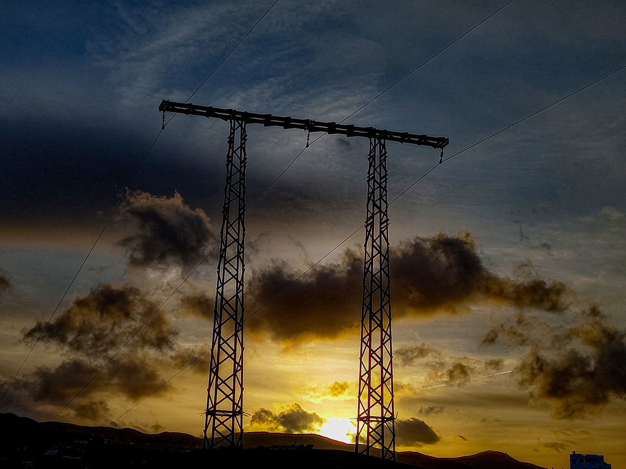 LOW ANGLE VIEW OF SILHOUETTE ELECTRICITY PYLONS AGAINST SKY