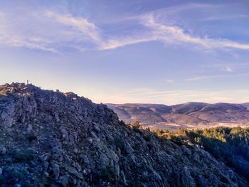 Scenic view of mountains landscape with hiker on the peak