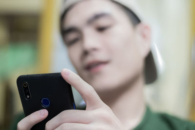 Close-up portrait of man using mobile phone