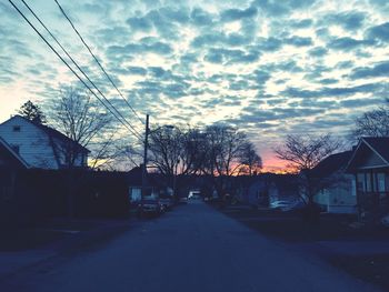 Road against cloudy sky at sunset