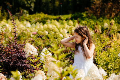 Cute girl sitting on plants