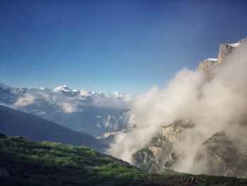 Scenic view of mountains against blue sky