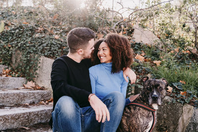 Young couple sitting outdoors