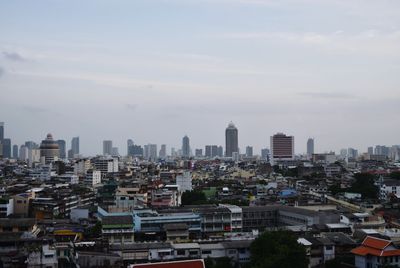 High angle view of buildings in city against sky