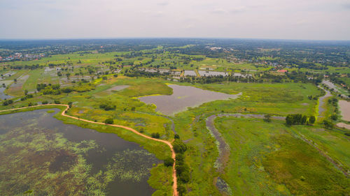 High angle view of green landscape against sky