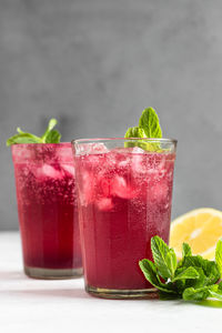 Sparkling pink lemonade with lemon and mint. summer refreshment drink.