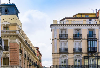 Low angle view of buildings against sky in city