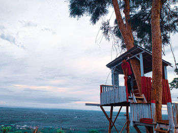 Lifeguard hut by building against sky