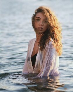 Portrait of young woman in water