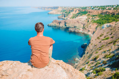 Rear view of man looking at sea