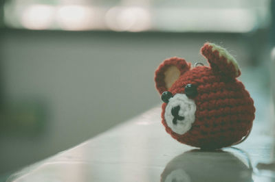 Close-up of knitted teddy bear on table