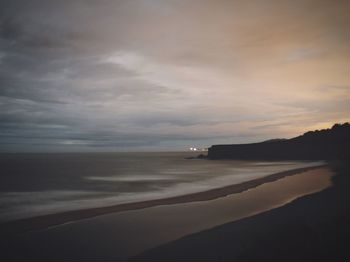 Scenic view of sea against cloudy sky