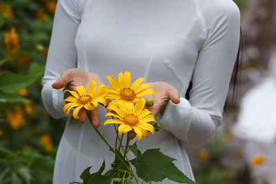 Close-up of woman against sunflower