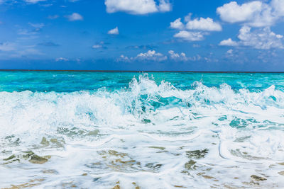 Scenic view of sea against cloudy sky