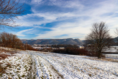 Snow covered field against sky