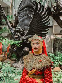 Portrait of young woman in costume standing outdoors