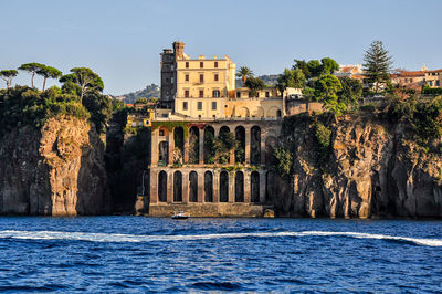 Arch bridge over water against clear sky