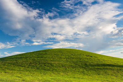 Scenic view of green landscape against sky