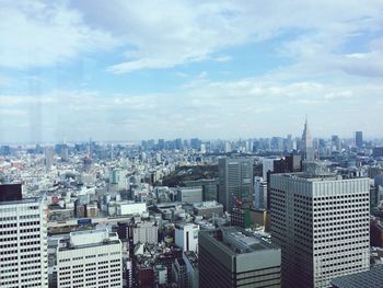 Cityscape against cloudy sky