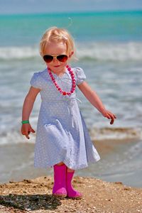 Portrait of cute girl standing on beach