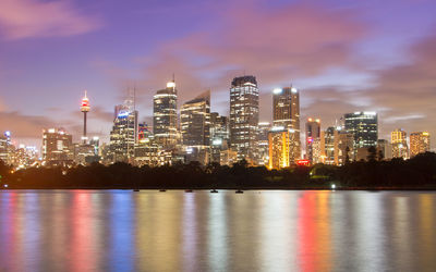 Illuminated buildings against sky at night