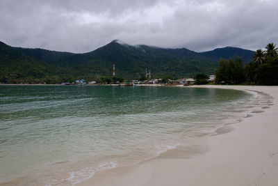 Scenic view of sea and mountains against sky