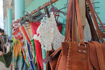 Clothes and purse hanging for sale at market